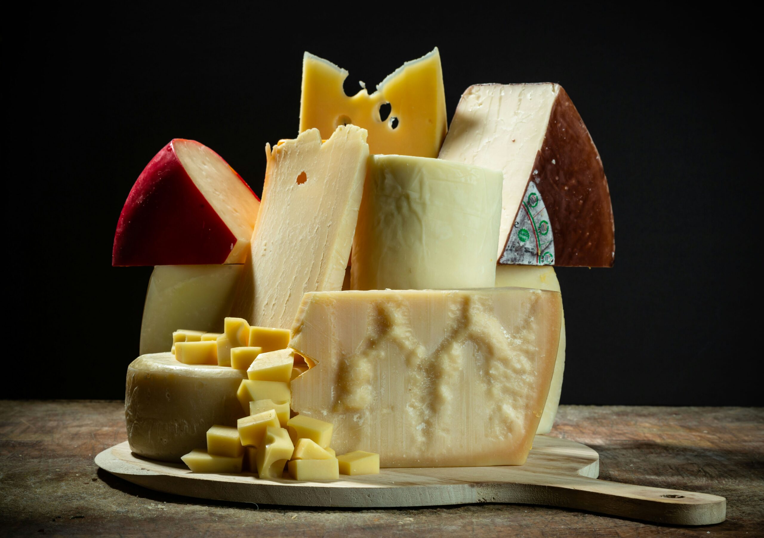 A stacked collection of different types of cheese